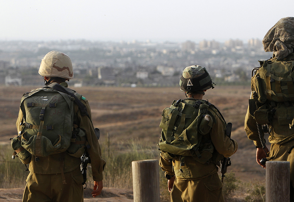 Israeli soldiers patrol near the border with the Gaza Strip