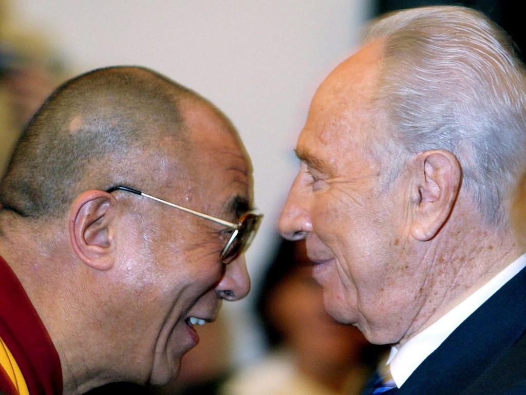 El ex presidente israelí Shimon Peres (d) junto al líder tibetano Dalai Lama (i), en la cuarta Cumbre Mundial de Premios Nobel por la Paz, en Roma. (EFE/Fotografía de archivo del 28 de noviembre de 2003)