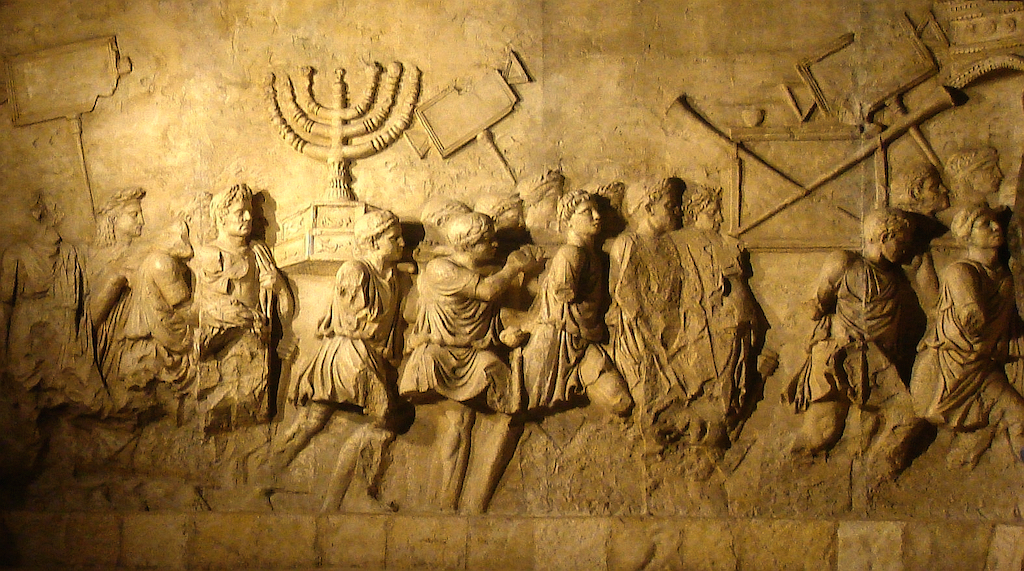 The Arch of Titus in Rome, depicting the triumphal parade of Roman soldiers leading away newly enslaved Jews after the sacking of Jerusalem in 70 CE (CC via Wikipedia)