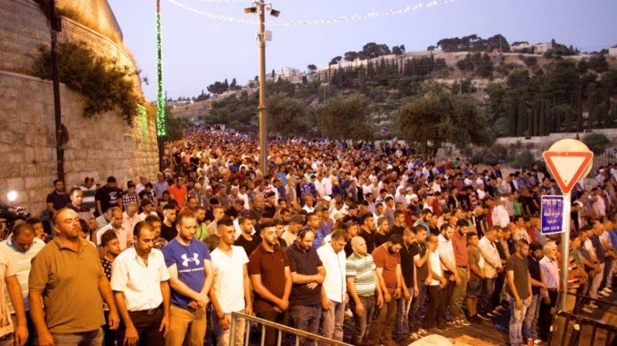 Thousands of Muslim worshipers participate in evening prayers outside the Lions Gate in the Old City of Jerusalem, refusing to enter the Temple Mount enclosure to reach the Al-Aqsa Mosque inside, July 25, 2017. (Dov Lieber /Times of Israel)