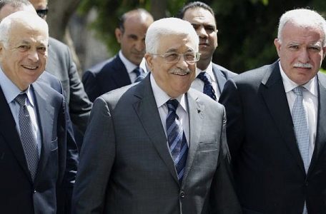 PA President Mahmoud Abbas (center), arrives with the Arab League's Secretary-General Nabil Elaraby (left), and Palestinian Foreign Minister Riyad al-Maliki (right) to attend a meeting of Arab foreign ministers at the Arab League headquarters in Cairo, Egypt, on Sunday, September 7, 2014. (photo credit: AP/Hassan Ammar)