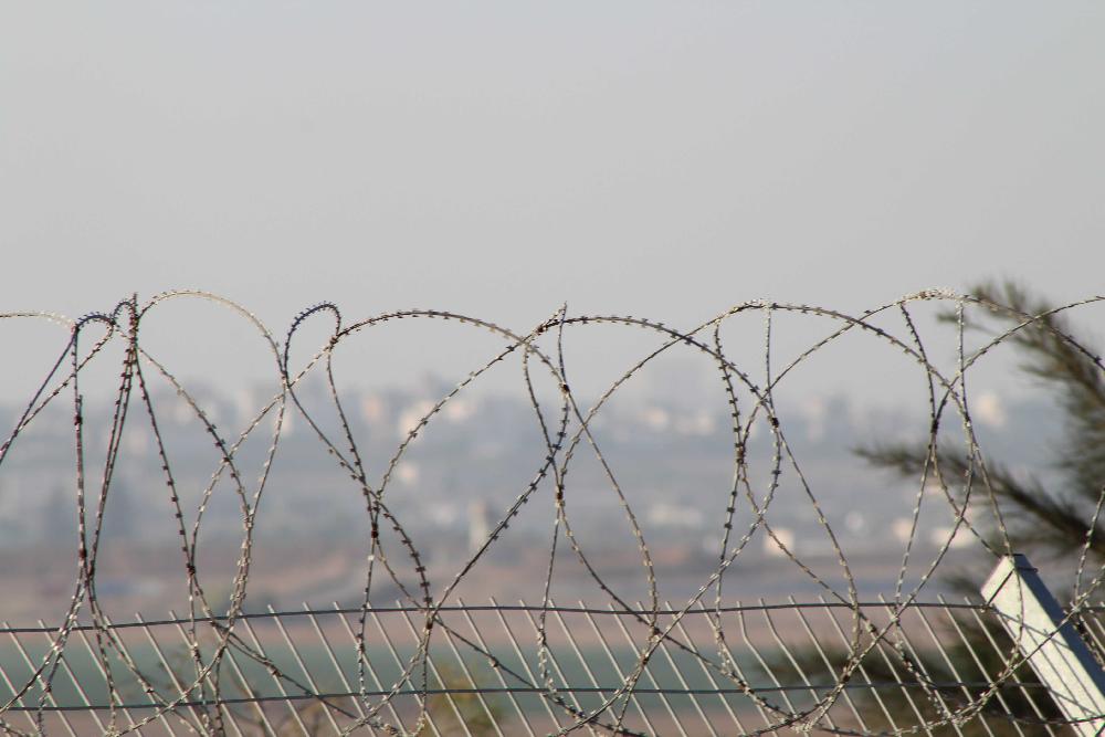 Gaza al fondo de la imagen y en primer plano, la cerca de seguridad.